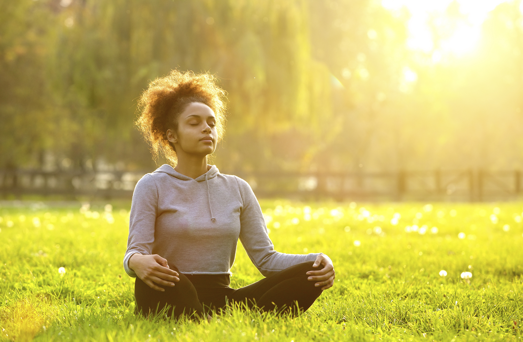 Young african american woman meditating in nature